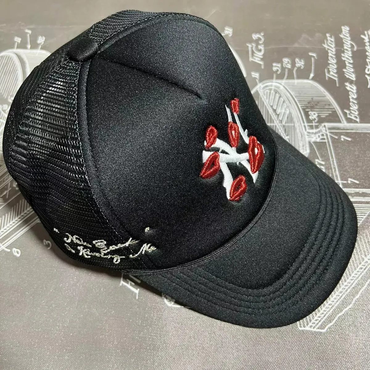 Black Embroidered Trucker Hat with Red Lip Design